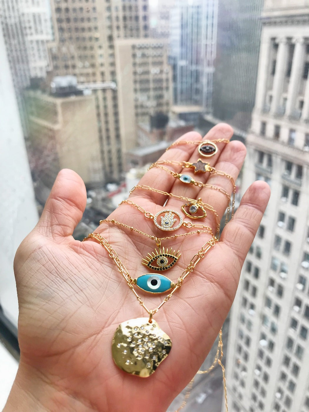 layered cz evil eye charm necklaces in gold