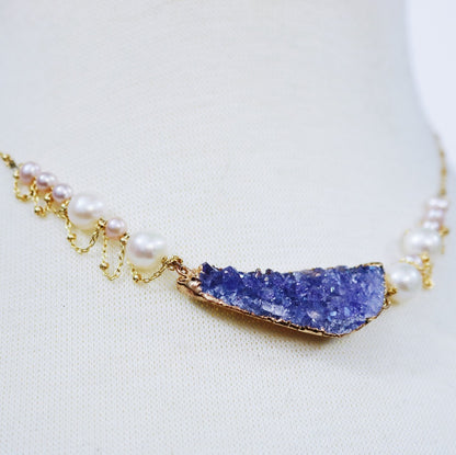 side view of purple drusy necklace with pearls and gold chain
