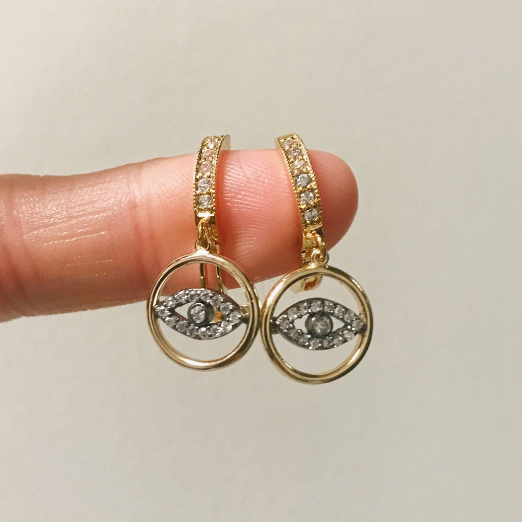 gold and silver two-tone CZ evil eye huggie earring