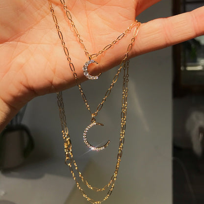 Rachel Mulherin CZ Crescent Moon necklace on gold chain layered with CZ mini moon necklace
