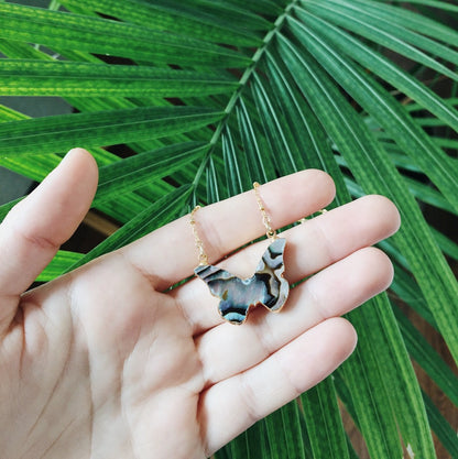 abalone and gold butterfly necklace in hand