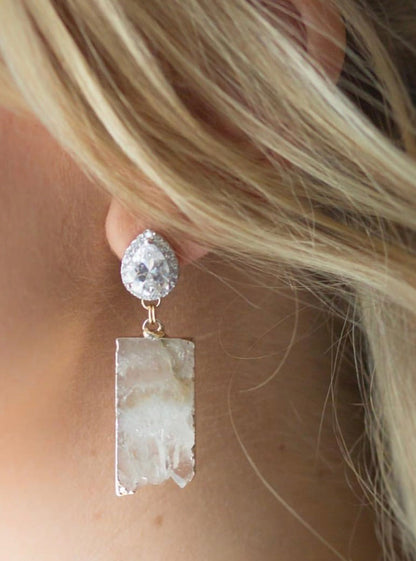 white amethyst CZ statement earrings on a blonde bride in ear