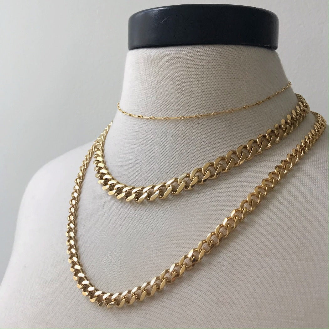 basic gold layered curb chains on neck