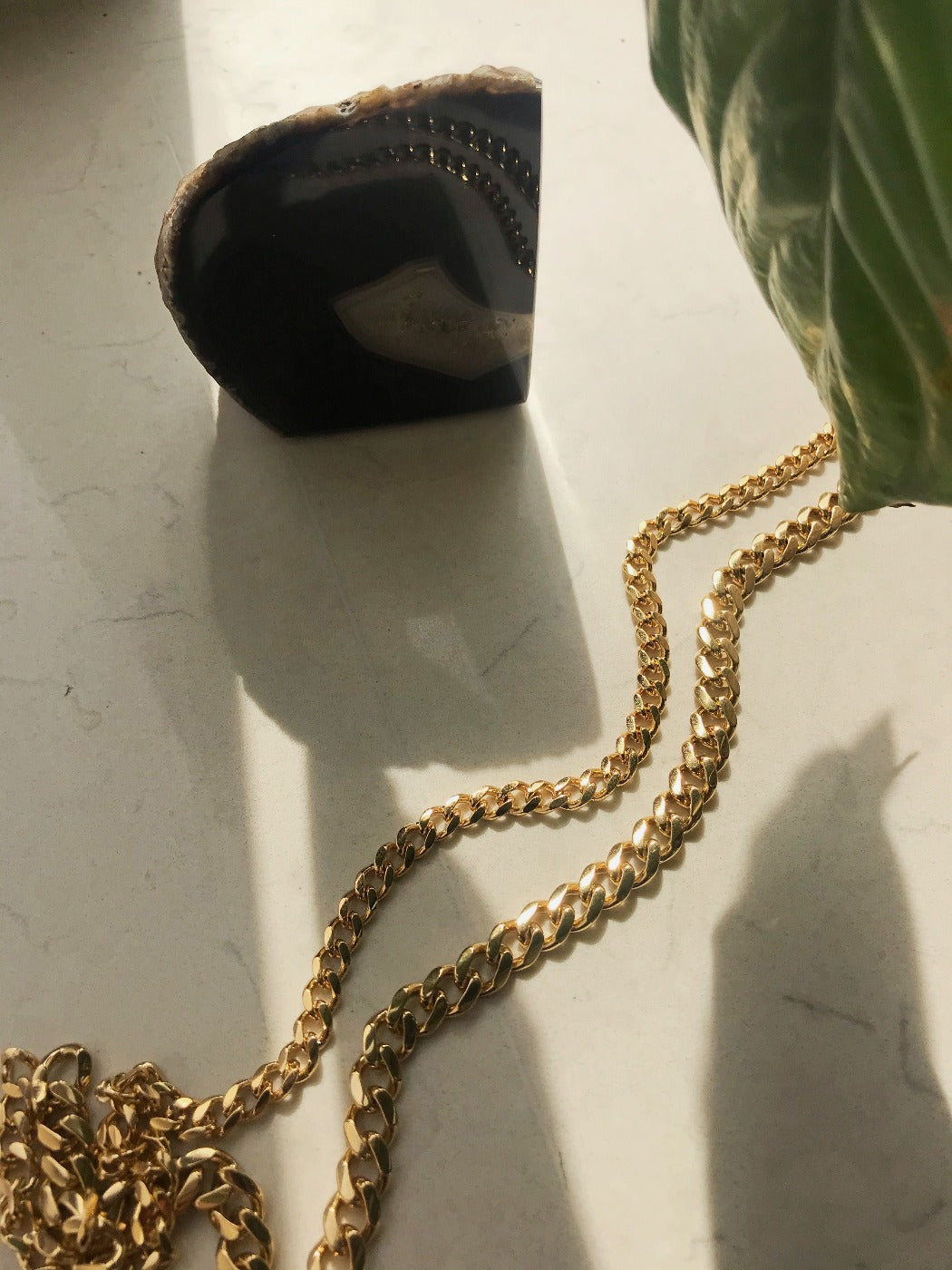 Rachel Mulherin basic gold layered curb chains on marble
