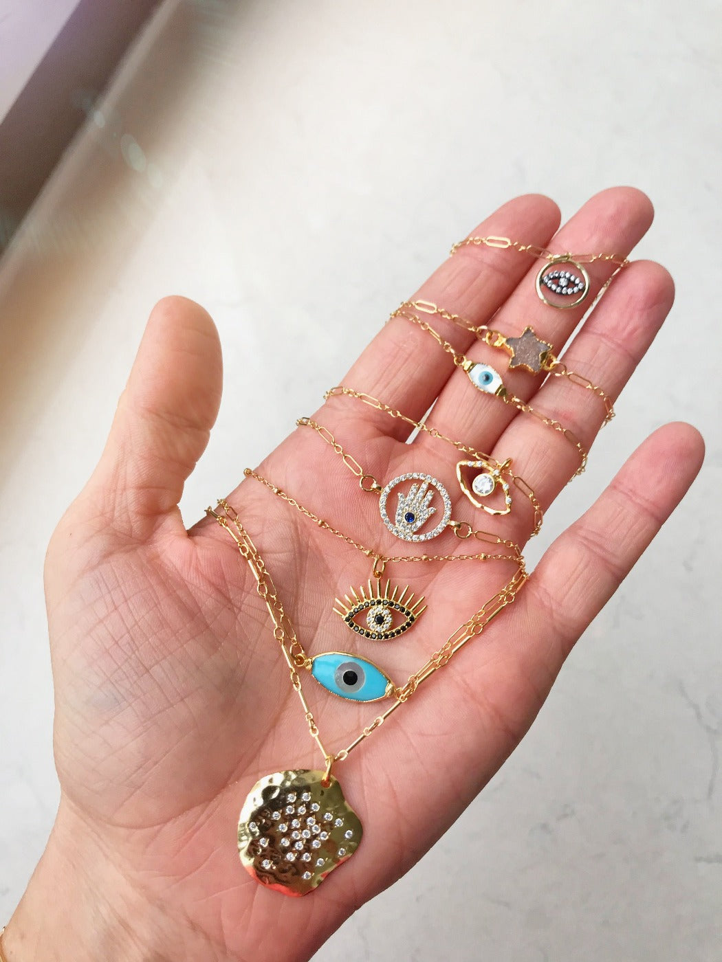 layered cz evil eye charm necklaces in gold