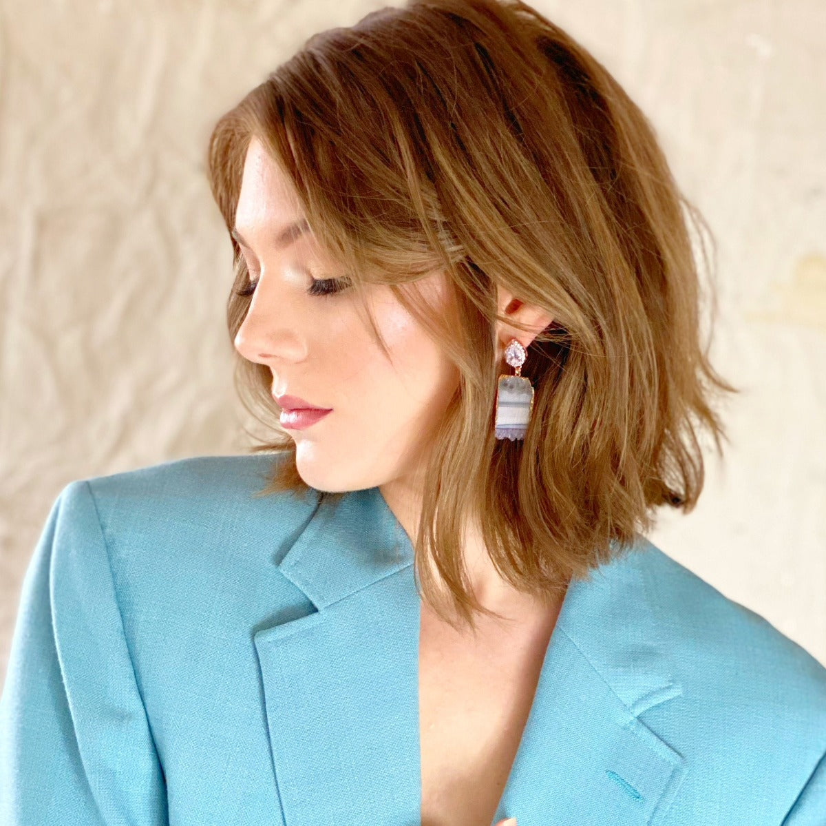 amethyst statement earrings paired with blue blazer
